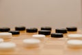 Brown wooden chessboard with classic checkers. Table game. Checkers on the playing field for the game Royalty Free Stock Photo