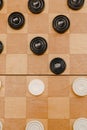 Brown wooden chessboard with classic checkers. Table game. Checkers on the playing field for the game Royalty Free Stock Photo