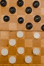 Brown wooden chessboard with classic checkers. Table game. Checkers on the playing field for the game Royalty Free Stock Photo