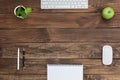 Brown Wooden Desk with Stationery Electronics Flora and Food Royalty Free Stock Photo