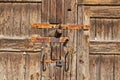 Brown wooden door with rusty handles and locks Royalty Free Stock Photo