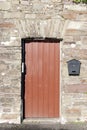 Brown wooden doorway and a post box Royalty Free Stock Photo