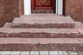 Brown wooden entrance door with a stone threshold . Royalty Free Stock Photo