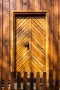 Brown wooden facade and doors of Polish highlander mountain style small chapel in Zywiec Beskid Mountains, Milowka, Poland Royalty Free Stock Photo