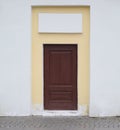 Brown wooden false door in a yellow-white wall Royalty Free Stock Photo