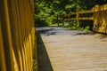 Brown wooden fence paved bridge walking trail distant view Georgia