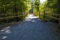 Brown wooden fence paved bridge walking trail