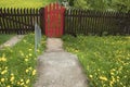 Brown wooden fence and a red gate