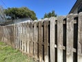Brown wooden fence shadow box style blue sky summer Royalty Free Stock Photo