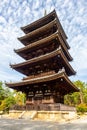 Brown wooden five-storied Buddhist pagoda with blue sky in autumn in Ninna-ji Temple Garden, Kyoto, Japan.