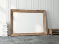 Brown wooden Horizontal Frame Mockup standing near white wall in living room