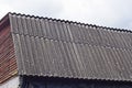 Brown wooden loft of a rural house under a gray slate roof Royalty Free Stock Photo