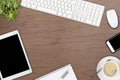 Brown wooden office desk top view with office utensils, plant an Royalty Free Stock Photo