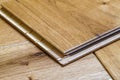 Brown wooden parquet floor planks installation , close up. Carpentry concept. Royalty Free Stock Photo