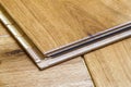 Brown wooden parquet floor planks installation , close up. Carpentry concept. Royalty Free Stock Photo