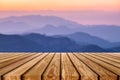 Brown wooden plank on layer colorful mountain