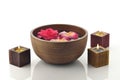 Brown Wooden Spa Bowl on White Background with Candles and Flowers Royalty Free Stock Photo