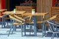 Brown wooden table and chairs on the sidewalk outside in the summer cafe Royalty Free Stock Photo
