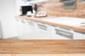 Brown wooden table top and blurred kitchen interior background Royalty Free Stock Photo