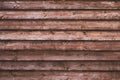 Brown wooden texture at horizontal striped. Dark weathered hardwood. Retro rough oak fence. Old wood plank background. Vintage tex Royalty Free Stock Photo