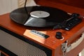 Brown wooden turntable with dusty vinyl record in sunlight. Retro vinyl digital player, nostalgic music modern trend