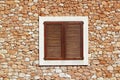 Brown wooden window in masonry wall Royalty Free Stock Photo