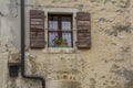 Brown wooden window shutters on the stone house Royalty Free Stock Photo