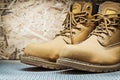 Brown working boots on plywood background Royalty Free Stock Photo