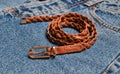 Brown woven leather belt close-up on blue jeans Royalty Free Stock Photo