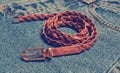 Brown woven leather belt close-up on blue jeans Royalty Free Stock Photo