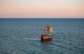 Brown yacht on a sea with sunset light