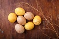 Brown and yellow Easter eggs on rustic table, colored with coffee and turmeric. Happy Easter concept, top view Royalty Free Stock Photo