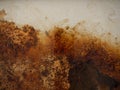 Brown and yellow wet rust and dirt on white enamel with smudges of water and drops Royalty Free Stock Photo