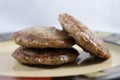 Browned sausage patties stacked on saucer plate