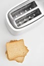 Browned toast near white new toaster Royalty Free Stock Photo