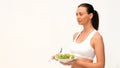 Brownhaired woman eating a salad