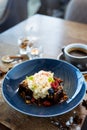 Brownie cake with salted caramel. Anglaise foam, raspberry sauce, praline nut and fresh berry. Delicious sweet dessert Royalty Free Stock Photo