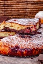 Brownie with cherries on wooden rustic table.