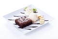 Brownie and ice cream with whipping cream and banana slices