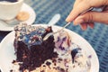 Brownie with icecream. sweet and dessert. female hand with a spoon separates a piece of cake Royalty Free Stock Photo