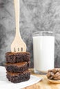 Brownie stack and fork with milk in glass background