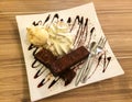 Brownie with Vanilla Ice Cream with Chocolate Sauce Served on White Dish Royalty Free Stock Photo