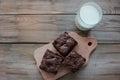 Brownies With Cherries On A Cut Board. Close-up Of Handmade Chocolate Cake And A Glass Of Milk On Wooden Table Background.