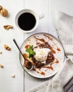 Brownies with ice cream and caramel sauce with a cup of espresso coffee on a white wooden background. Delicious chocolate-nut Royalty Free Stock Photo