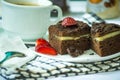 Brownies with slice of strawberry and cheese in the middle of cake