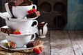 Brownies in stacked coffee cups with chocolate sauce