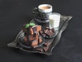 Brownies on a tray with milk and a Cup of Oriental coffee