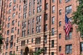 brownstone building architecture of new york. american flag on brick brownstone building. architectural exterior and