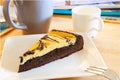 Browny cheese cake on white dish with coffee cup and relaxing ma