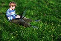 Browser (Child with notebook sit green grass) Royalty Free Stock Photo